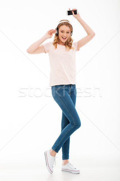 Stockfoto: Vrolijk · jonge · dame · luisteren · muziek · mobiele · telefoon