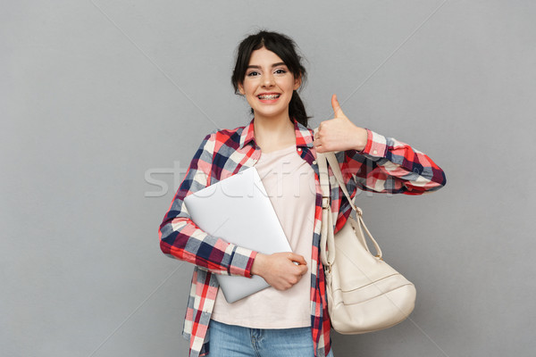 Amazing emotional young lady student showing laptop computer make thumbs up gesture. Stock photo © deandrobot