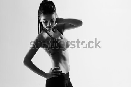 Black and white image of a young sport woman Stock photo © deandrobot