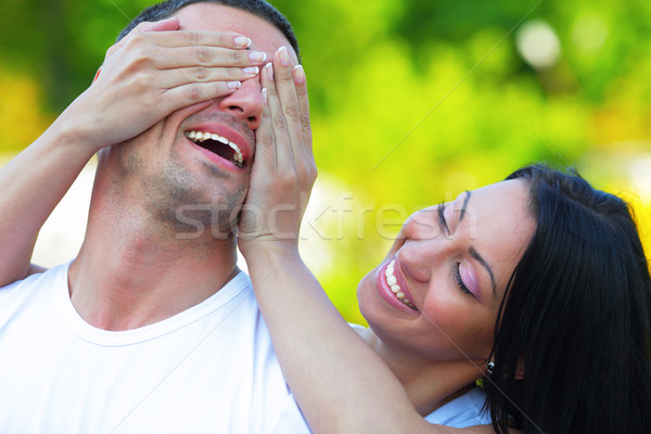 Happy woman holding hands on eyes of her boyfriend Stock photo © deandrobot