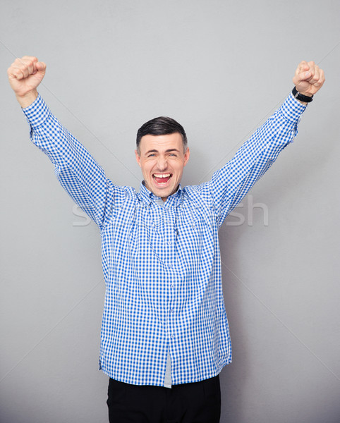 Homem as mãos levantadas para cima vitória gesto Foto stock © deandrobot