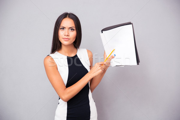 Portrait of a young woman showing contract Stock photo © deandrobot