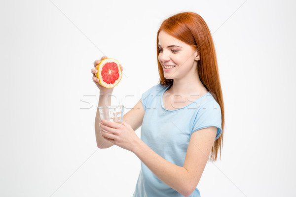 Fericit zâmbitor doamnă grapefruit suc Imagine de stoc © deandrobot