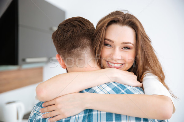 Couple hugging at home Stock photo © deandrobot