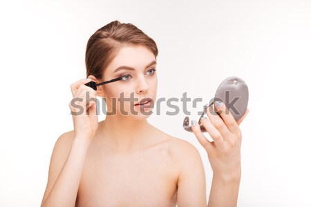 Woman applying mascara on her eyelashes Stock photo © deandrobot