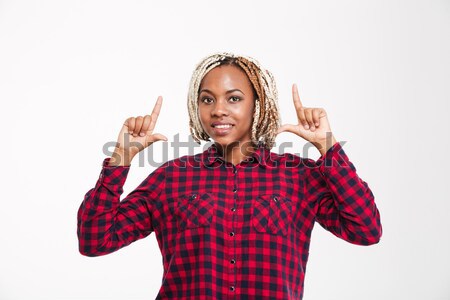 Derűs afroamerikai nő mutat felfelé mindkettő Stock fotó © deandrobot