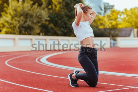 Back view of a female runner with mobile phone Stock photo © deandrobot