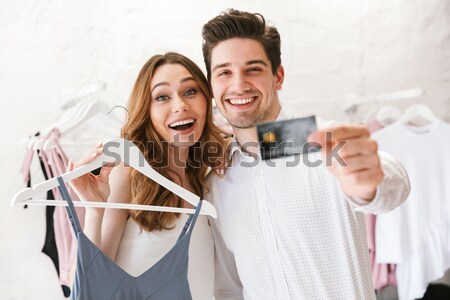 Two smiling women wearing bridal veil and holding champagne bottle Stock photo © deandrobot