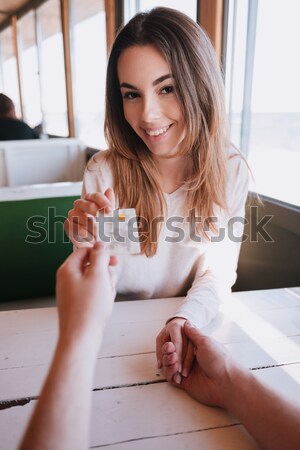 Couple in cafe by the table with credit card Stock photo © deandrobot