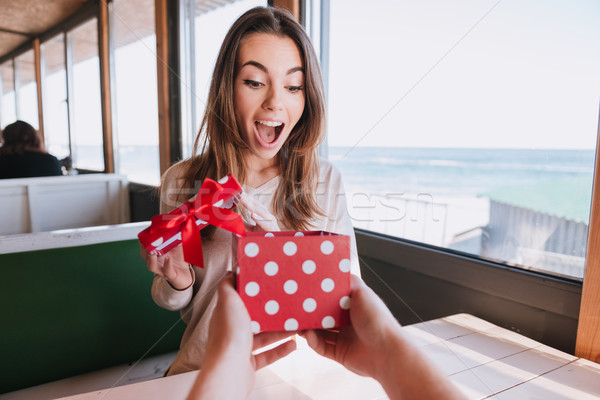 Surprised happy woman gets the gift Stock photo © deandrobot