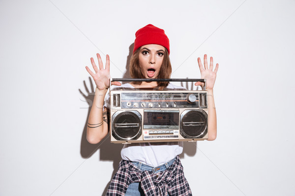 Young lady holding tape recorder. Stock photo © deandrobot