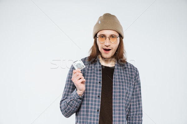Young hipster holding condom Stock photo © deandrobot