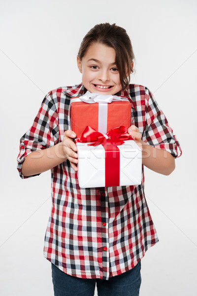 Happy young girl posing with two gifts Stock photo © deandrobot