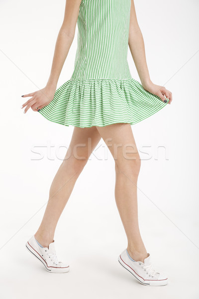 Half body portrait of a young girl in dress walking Stock photo © deandrobot