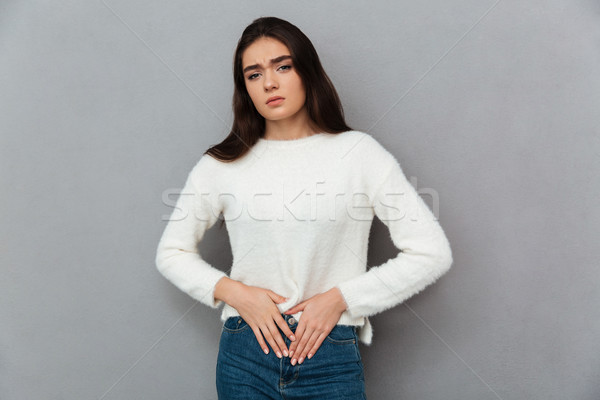 Close-up photo of depressed young woman with abdominal pain, loo Stock photo © deandrobot
