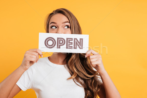 Close up portrait of a girl holding open door sign Stock photo © deandrobot