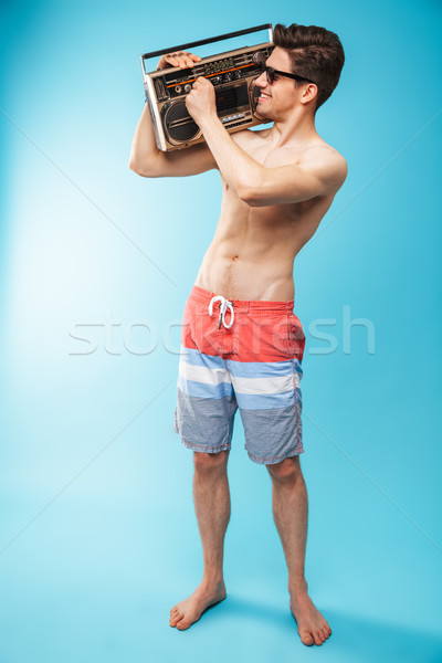 Full length portrait if a joyful shirtless man Stock photo © deandrobot