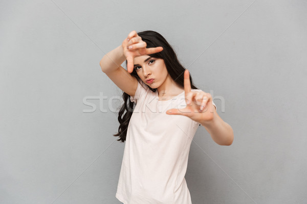 Young lady take a shot of you gesturing with hands Stock photo © deandrobot