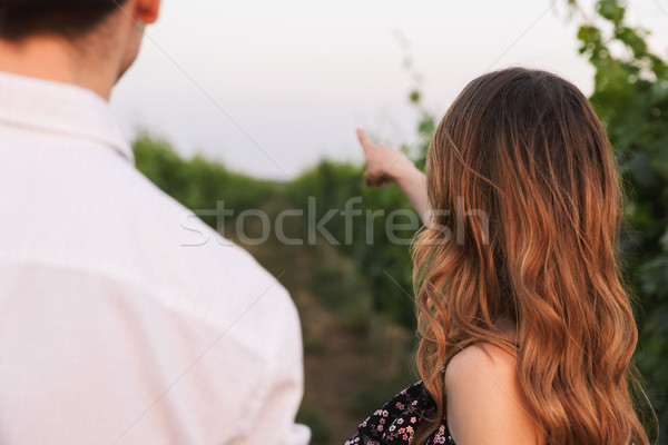 Photo from back closeup of european couple man and woman, walkin Stock photo © deandrobot