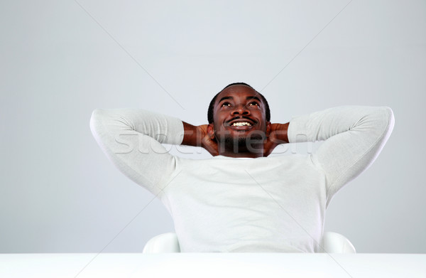 Nyugodt afrikai férfi ül asztal szürke Stock fotó © deandrobot