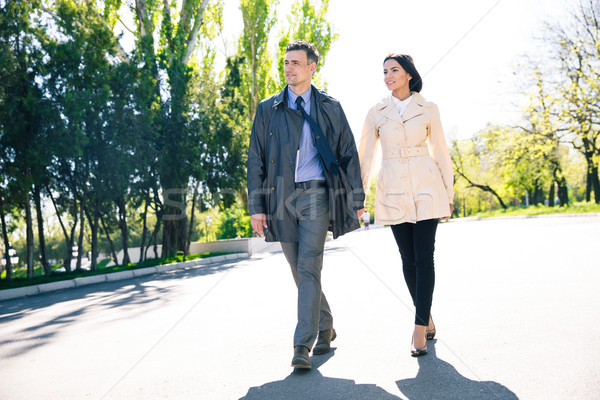 Smiling couple walking outdoors Stock photo © deandrobot