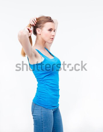 Fiatal nő tart haj lófarok izolált fehér Stock fotó © deandrobot