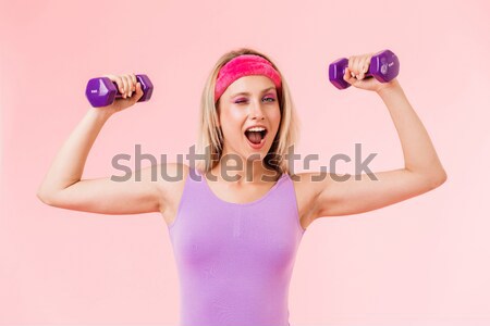 Angry woman workout with dumbbells Stock photo © deandrobot