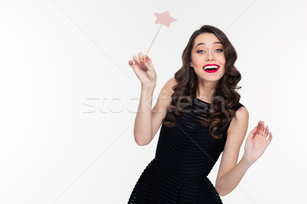 Cheerful beautiful curly young woman posing with magic wand Stock photo © deandrobot