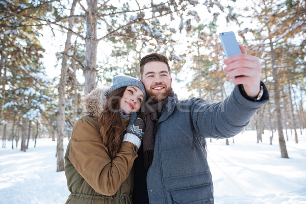 Couple making selfie photo in winter park Stock photo © deandrobot