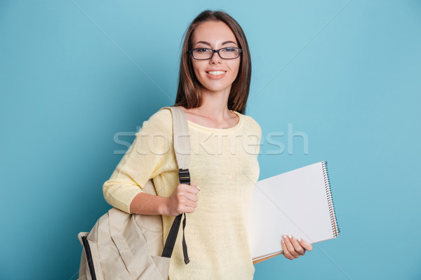 Hermosa joven cuaderno azul aislado mujer Foto stock © deandrobot