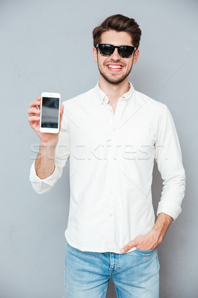 Stockfoto: Gelukkig · jonge · man · zonnebril · scherm · mobiele · telefoon