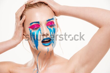 Portrait of beautiful woman looking away with hands near face Stock photo © deandrobot
