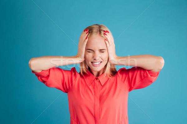 Stock photo: Beautiful young blonde woman covering her ears with palms