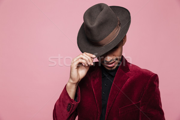 Close up portrait of a afro american man in hat posing Stock photo © deandrobot