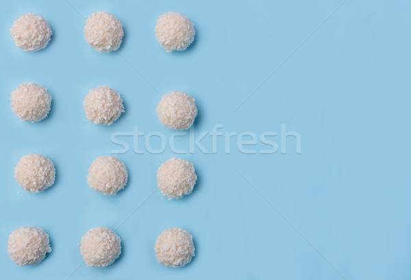 Coconut sweeties candy over blue table background. Stock photo © deandrobot