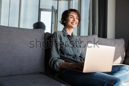 Business woman working with documents while sitting on sofa Stock photo © deandrobot