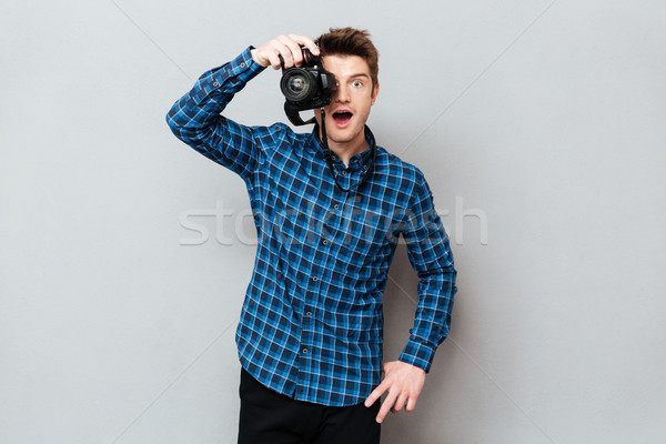 Surprised photographer working isolated Stock photo © deandrobot