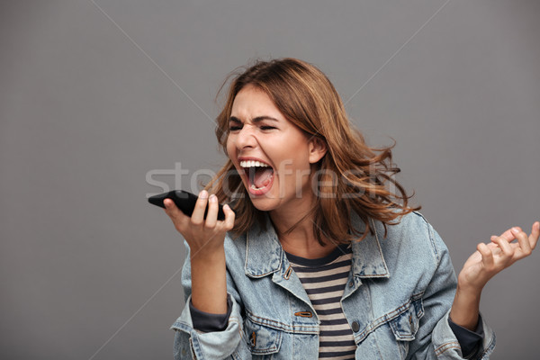 Portrait of a furious mad teenage girl Stock photo © deandrobot