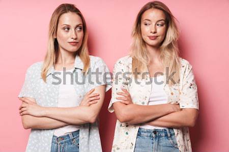 Portrait of two doubtful girls in colorful bright clothes Stock photo © deandrobot