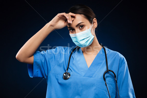 Tired doctor wipe sweat after operation isolated Stock photo © deandrobot