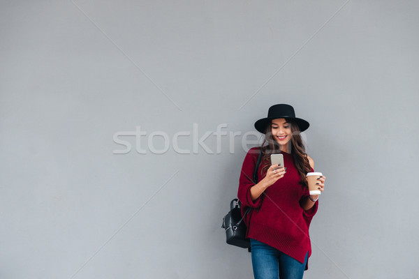 Stock photo: Portrait of a happy girl dressed in hat and sweater