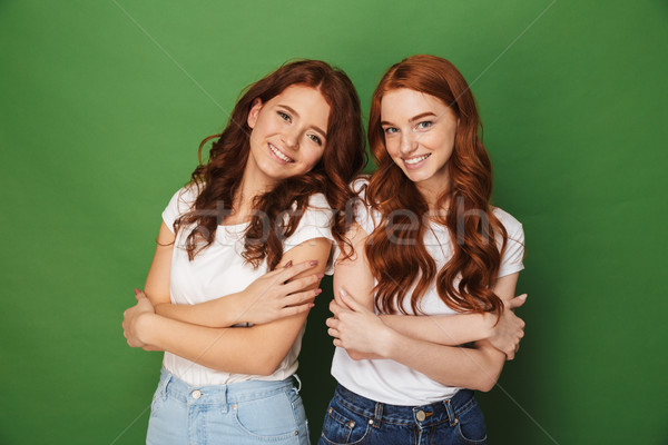 Portrait of two adorable girls 20s with ginger hair in casual we Stock photo © deandrobot