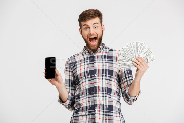 Portrait of a smiling young man in plaid shirt Stock photo © deandrobot