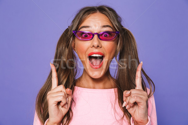 Portrait of an excited girl in sweatshirt in sunglasses Stock photo © deandrobot