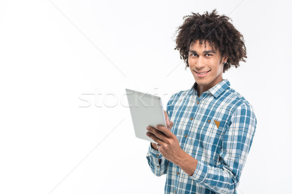 Smiling afro american man using tablet computer  Stock photo © deandrobot
