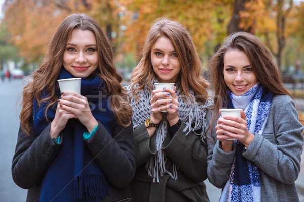 Stock photo: Three beautiful women drinking coffee outdoors 