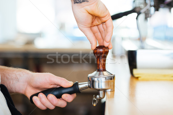 Closeup of portafilter with temper used by barista hands Stock photo © deandrobot