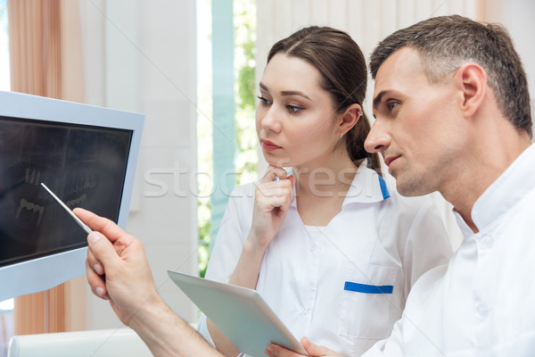 Férfi fogorvos mutat valami számítógépmonitor női Stock fotó © deandrobot