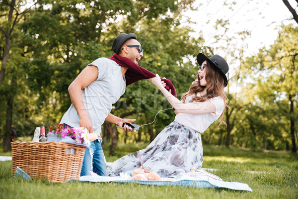 Couple listening to music from mobile phone and having fun Stock photo © deandrobot