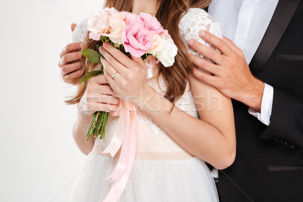 Cropped photo of couple with bouqute Stock photo © deandrobot